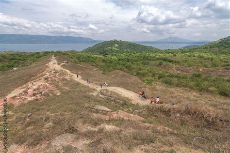 Tourists walking hiking trekking tour trail to Taal volcano, Batangas ...