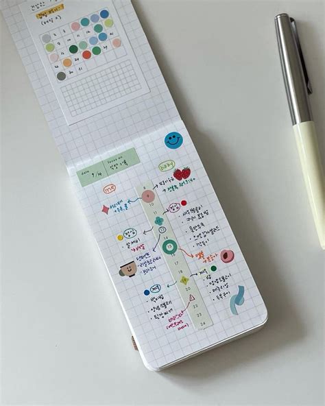 A Pen Sitting On Top Of A White Table Next To A Paper With Stickers