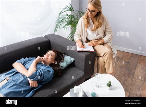 Happy Brunette Woman Lying On Sofa While Visiting Therapist Stock Photo Alamy