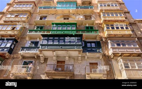 Traditional Maltese Wooden Balconies And Windows On A Residential Apartment Building In Central