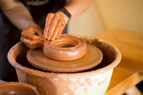 Hands Of Potter Makes Pottery Dishes On Potter Wheel Sculptor In