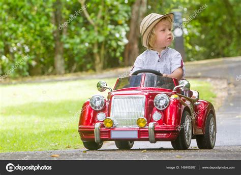 Child boy driving toy car Stock Photo by ©volare2004 148405207