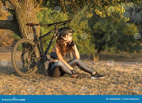 Girl On A Mountain Bike On Offroad Beautiful Portrait Of A Cyclist At