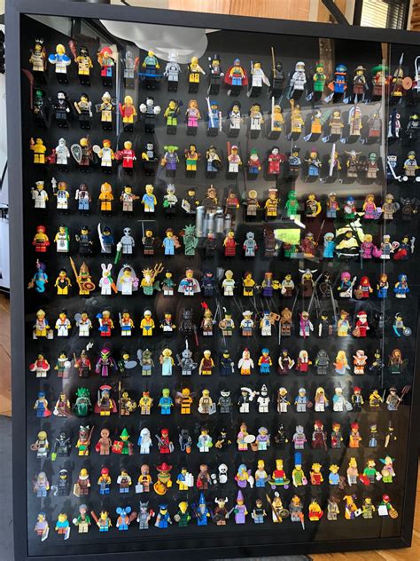 A Display Case Filled With Lots Of Lego Minifigure Figurines On Black