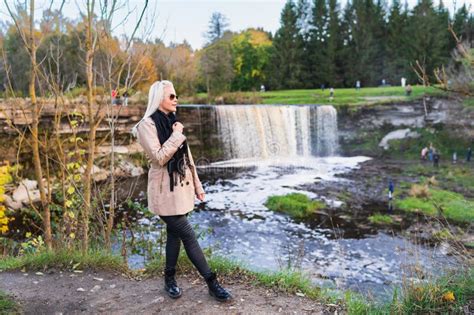 Slender Blonde Girl In Nature Near Jagala Waterfall On A Spring Evening Nature Of Estonia Stock