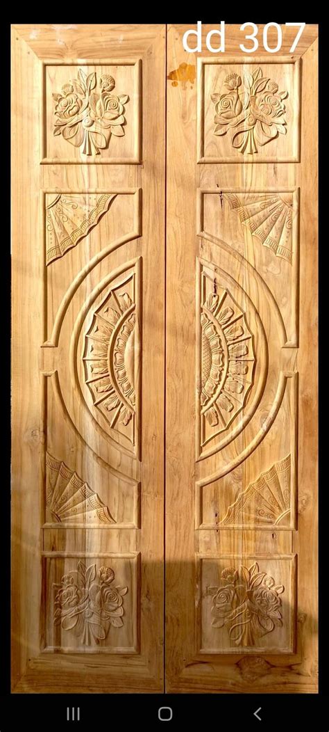 Two Wooden Doors With Carvings On Them