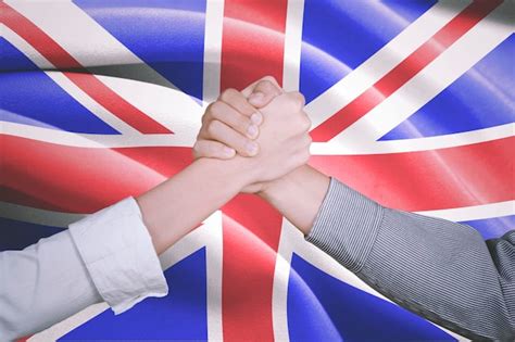 Premium Photo Cropped Image Of People Holding Hands Against British Flag