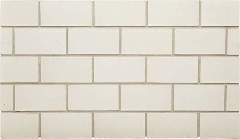 a white brick wall that is very close to the ground