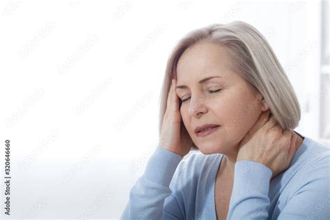 Woman Suffering From Stress Or A Headache Grimacing In Pain As She