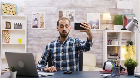 Creative young man using his phone to record a new episode for social