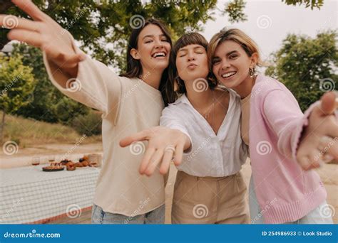 Positive Young Caucasian Women Stretch Their Hands To Camera Relaxing