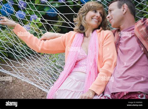 Close Up Of A Mature Couple Lying In A Hammock And Smiling Stock Photo Alamy