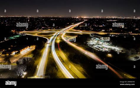 Aerial View Of A Bustling City Skyline Featuring A Highway In The