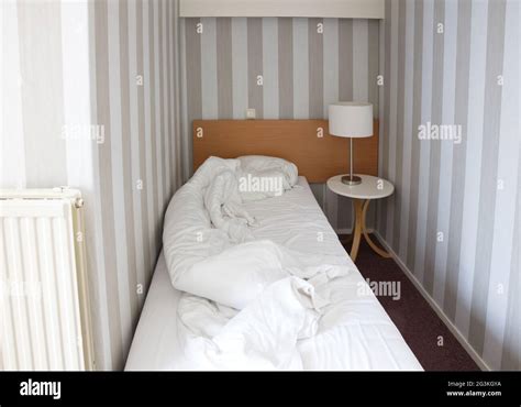 Simple hotel room, single bed Stock Photo - Alamy