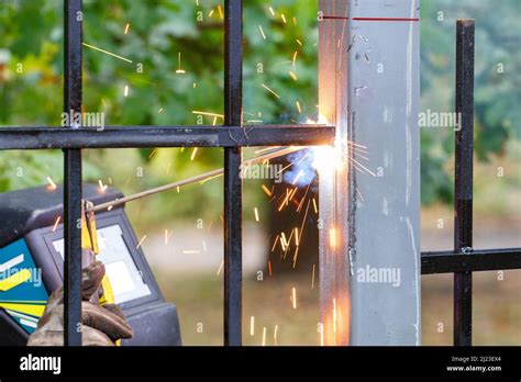 Bright Sparks From The Arc Of Electric Welding Fly In Different