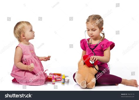 Children Playing Doctor Doll Isolated On Stock Photo 70673119