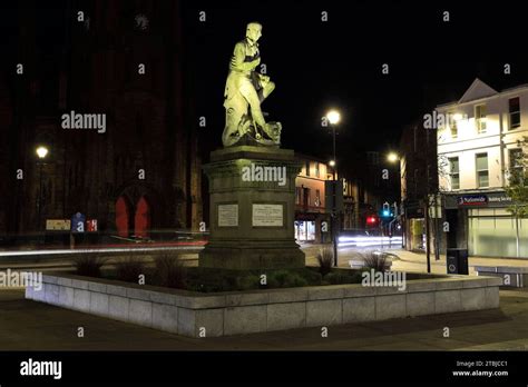 The Poet Robert Burns Statue In Dumfries Town Centre Greyfriars Church Behind At Night Scotland