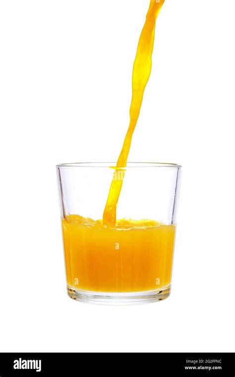 Pouring Orange Juice In Glass Isolated On White Background Stock Photo