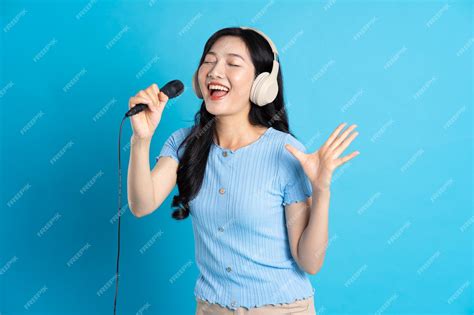 Premium Photo Portrait Of Smiling Asian Woman Posing On Blue Background