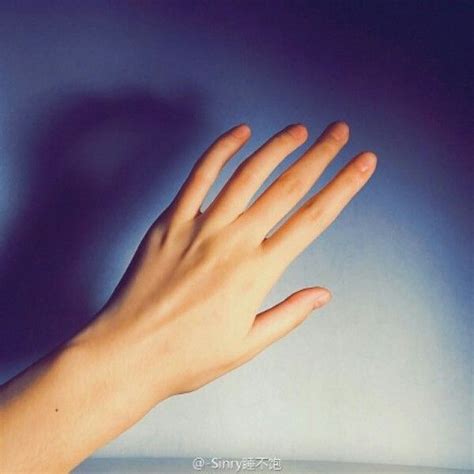 A Person S Hand Reaching Up Into The Air With Their Left Hand On Top Of It