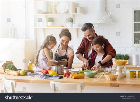 Happy Family Cooking Together On Kitchen Stock Photo 1660483093 ...