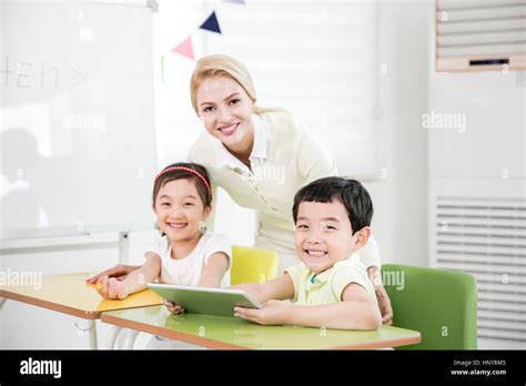 Smiling Kindergarten Children With Foreign Teacher Stock Photo Alamy