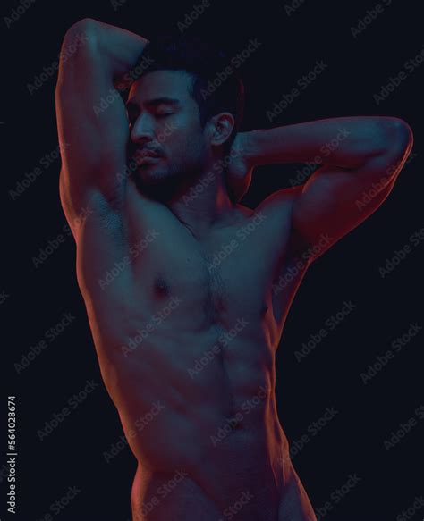 Erotic Nude And Body Of A Sexy Asian Man In Dark Light Isolated On A Black Background