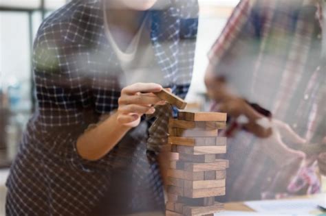 Premium Photo Midsection Of Man Stacking Wooden Block In Office