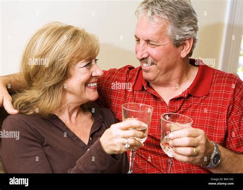 Beautiful Mature Couple Enjoying A Glass Of Wine And Gazing Into Each