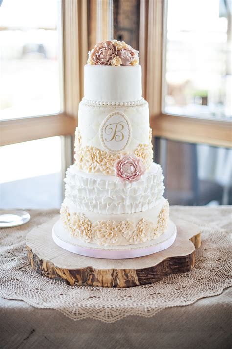 Romantic Wedding Cake With Lots Of Ruffles And Sugar Peonies And A Hand