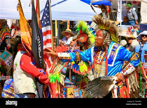 Male Native America Warriors Holding The Us Flag Wearing Ceremonial