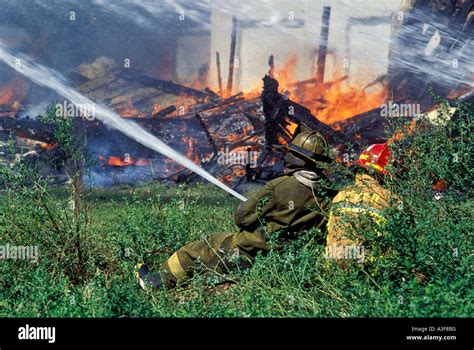 Volunteer Firemen Extinguishing Controlled Structure Fire As Practice Exercise Indiana Stock