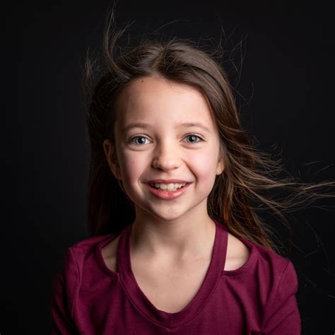 Premium Photo Portrait Of Cute Girl Standing Against Black Background