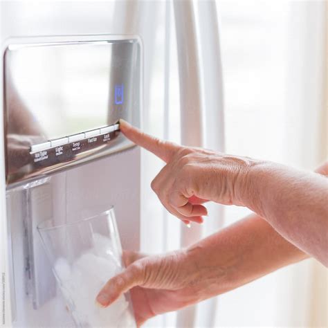 "Woman Dispenses Filtered Water From Her Fridge" by Stocksy Contributor ...