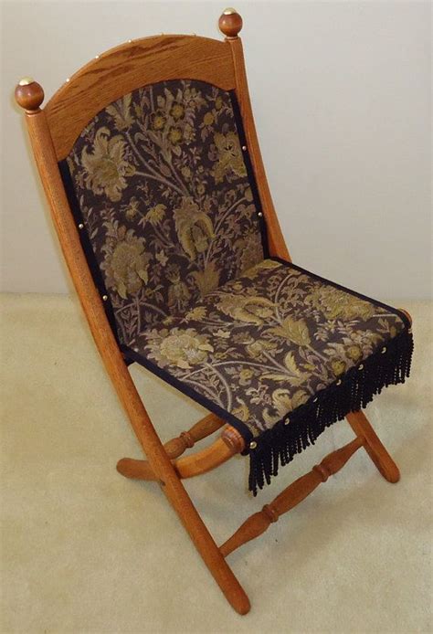 A Wooden Rocking Chair With Floral Fabric On It S Back And Seat Cushion