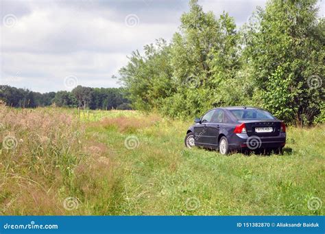 A Car Is Parked On The Grass Outside The City Editorial Image Image