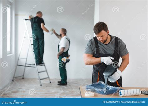 Renovation Crew Painting Walls Of New Build Apartment Stock Image