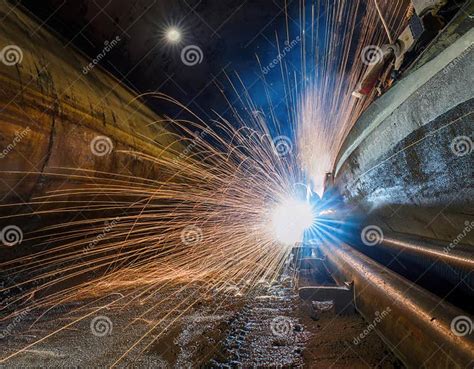 workers perform welding   tunnel creating bright sparks