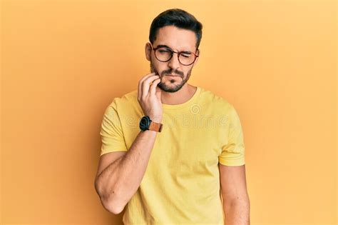 Young Hispanic Man Wearing Casual Clothes And Glasses Touching Mouth