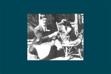 a black and white photo of a man sitting on a chair