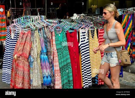 Bangkok, Thailand: Woman looking at women's clothing display at a shop ...