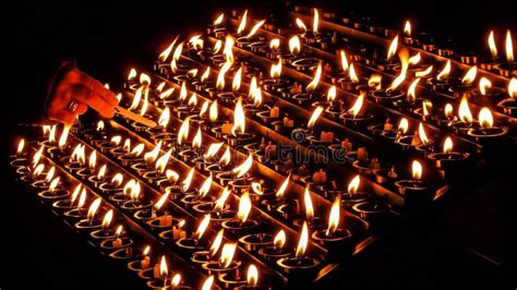 Woman Lighting Prayer Candle in a Church Stock Photo - Image of bright, candles: 57464998