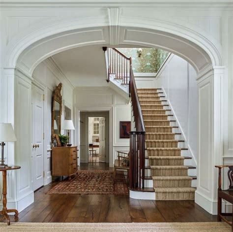 An Entry Way With Stairs Leading Up To The Second Floor And Another