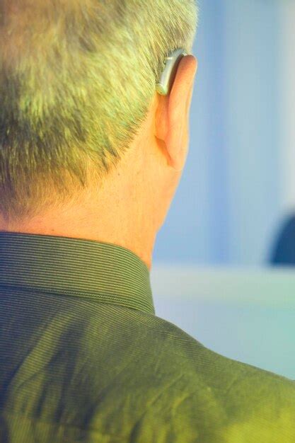 Premium Photo Close Up Of Man Wearing Hearing Aid At Night