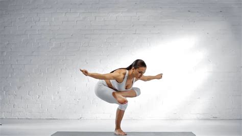 Fit Woman Balancing On One Leg While Doing Yoga Pose Stock Image