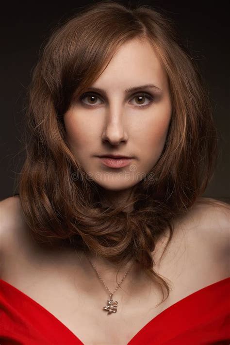 Authentic Brunette Model Girl With Nude Makeup And With Trendy Hairstyle In A Red Short Dress