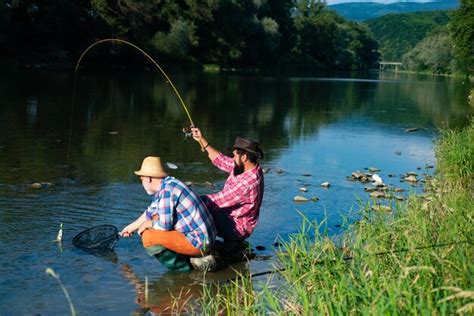 Premium Photo Two Men Friends Fishing Flyfishing Angler Makes Cast