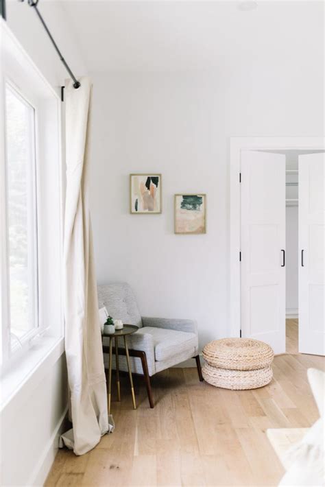 A Living Room With White Walls And Wooden Floors