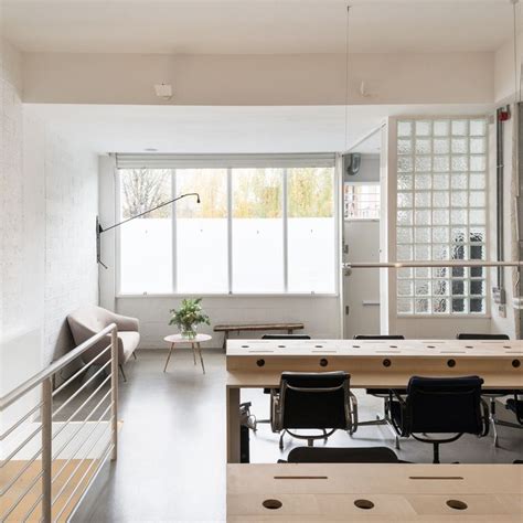 an office with white walls and wooden floors