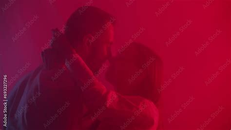 Couple Kissing Foreplay On Neon Light Background Young Caucasian Man